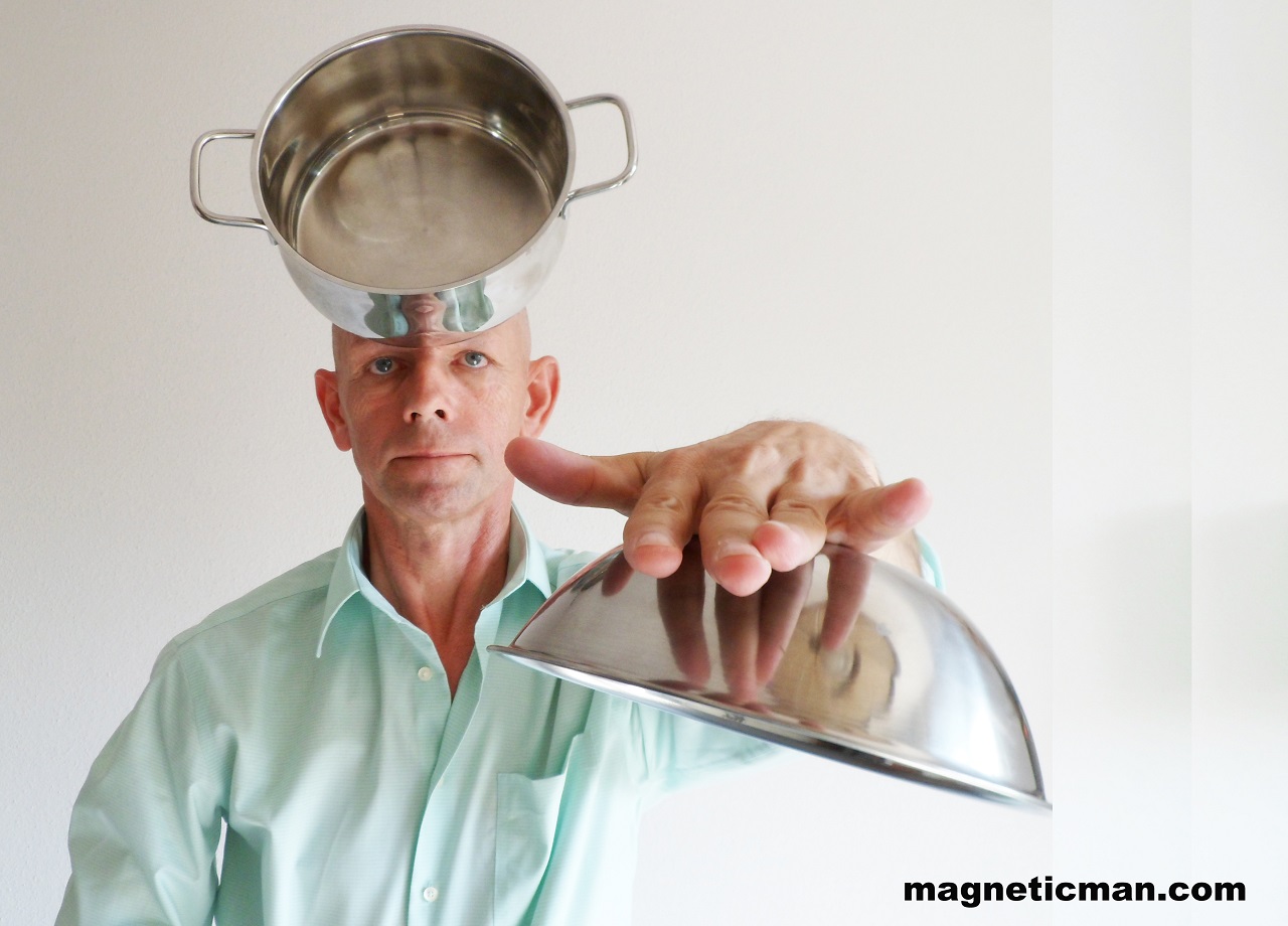 Miroslaw Magola Magnetic Man lifting metal pan with psychokinetic focus